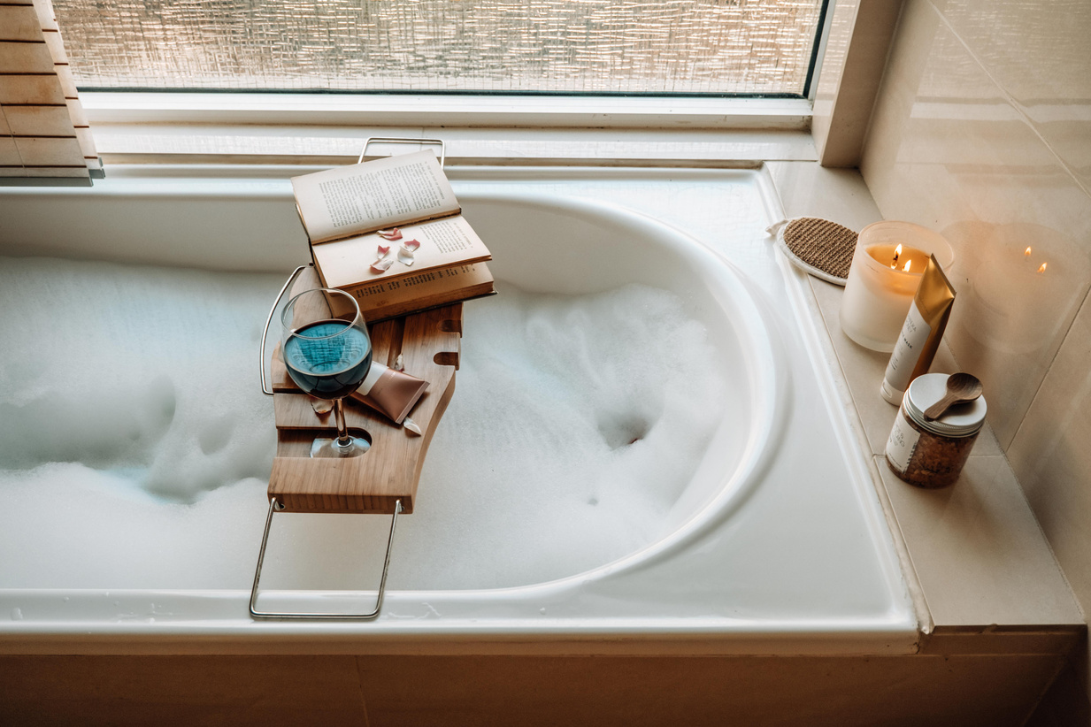 Book, Wine, and Skincare Products at the Tub